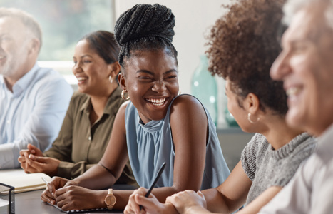 A group of people laughing around a table together